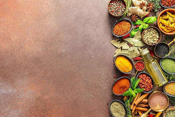 istock A diverse collection of vibrant spices and herbs, elegantly positioned on a brown backdrop, exuding natural beauty and a burst of fragrances 2223470593