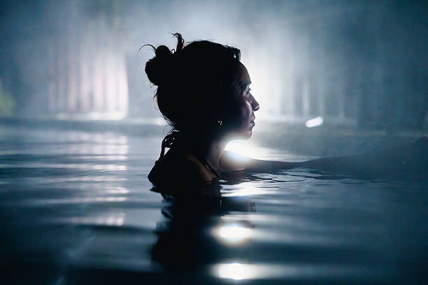 istock Serene woman relaxing in steamy hot spring 2223472303