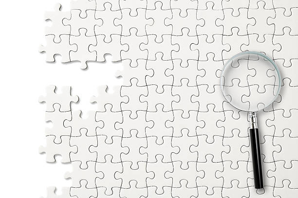 istock Magnifying glass on a blank jigsaw puzzle 2223477057