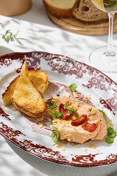 istock Hummus with tomatoes and toast, bright sunlight, overhead plating arrangement 2223478540
