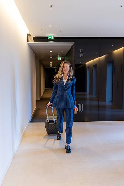 istock A professional woman walking elegantly in a modern office corridor, exuding confidence and ambition 2223478844