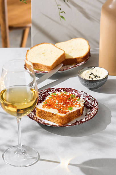 istock Brioche with butter and red caviar, bright natural lighting, elegant overhead composition 2223479842