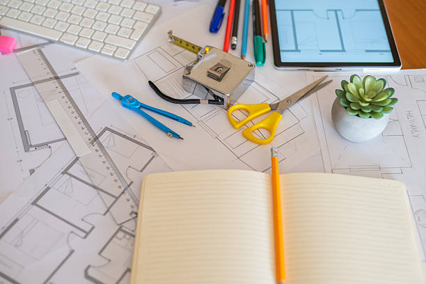 istock Workplace of an architect or engineer designing sustainable buildings with eco-friendly materials and modern software, surrounded by blueprints, tools, and a digital tablet 2223482084