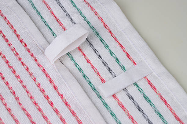 istock multi-colored striped terry towels for the kitchen with a loop for hanging on a hook, isolated 2223482093