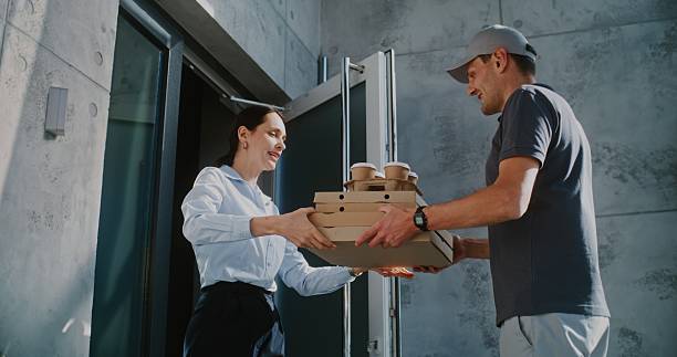 istock Delivery Man Brining Restaurant Food, Confirming Successful Delivery Using Smartphone 2223486764