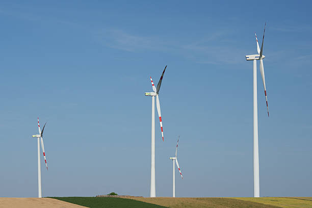 istock Four modern wind turbines under a clear blue sky in a field. Austria. 2223489649
