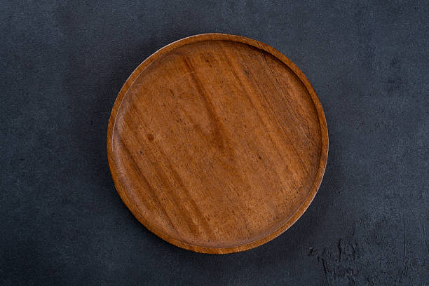 istock Empty wooden  plate on black background 2223490503