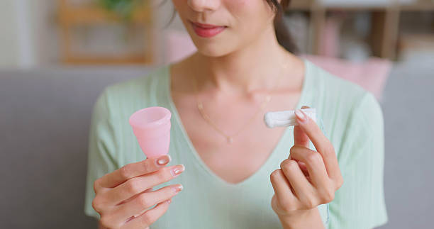 istock woman choosing tampons or Menstrual cup home 2223496855