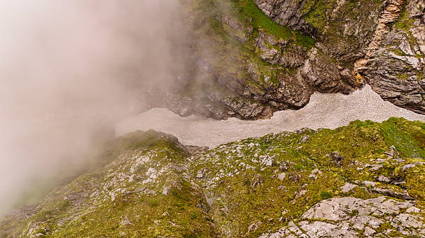 Fog-Covered Glacier Path in Rugged Mountain Valley  Aerial View