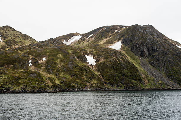 istock Rocky Fjord side Mountain with Snow 2223501476
