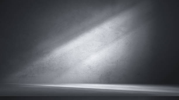 istock Dramatic grey concrete wall and floor with diagonal light beam, perfect for abstract product background, industrial showcase, or minimalist presentation. 2223501731
