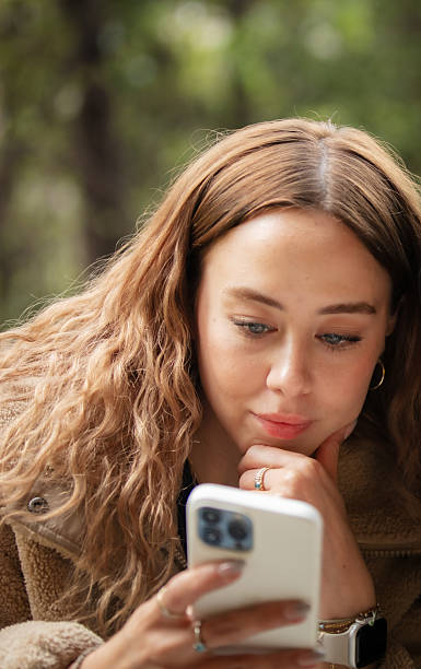 istock Young woman is looking at her mobile phone screen. 2223503096