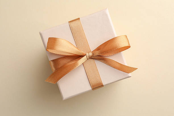 istock Beautiful gift box with golden bow on beige background, top view 2223503160