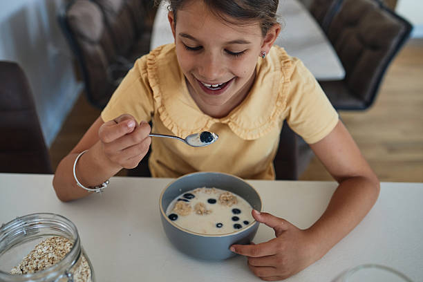 istock Young girl having breakfast at home 2223504572