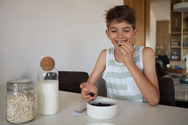 Young boy having breakfast at home