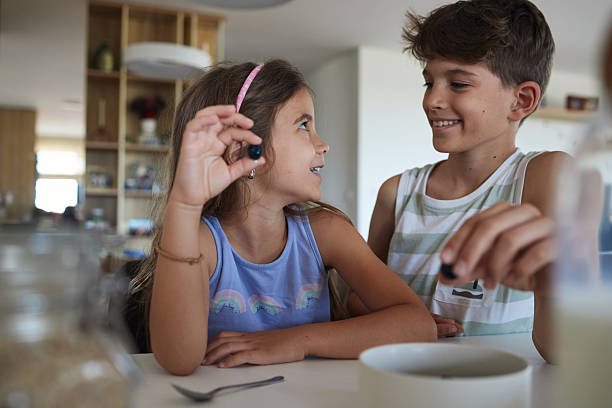 Young children having breakfast at home