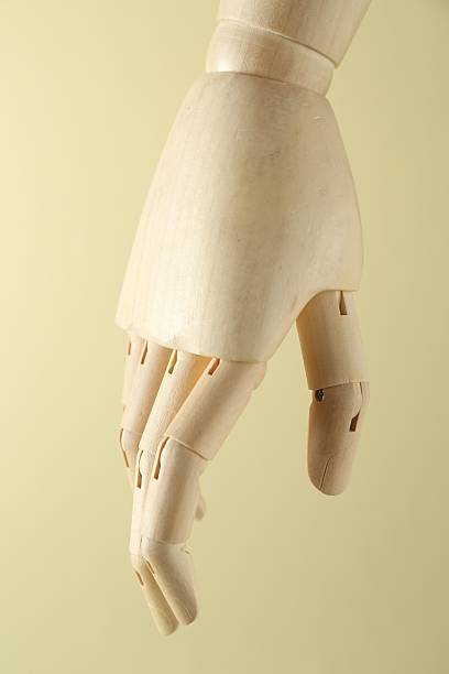 istock Wooden mannequin hand on beige background, closeup 2223505108