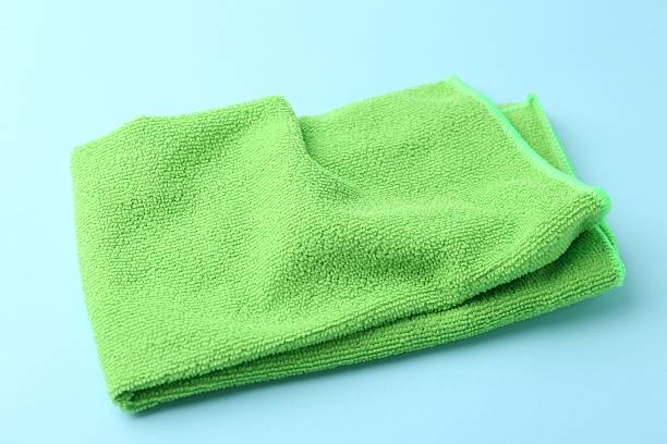 istock Clean green microfiber cloth on light blue background, closeup 2223505293