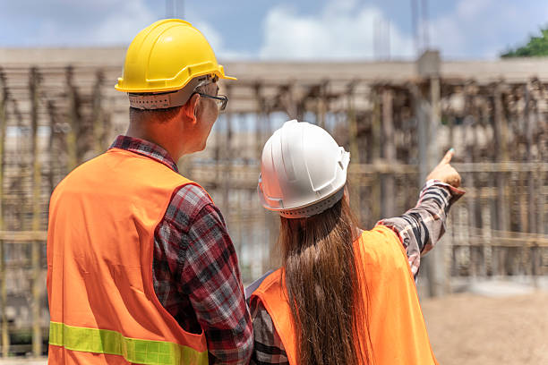 istock Construction Manager and Engineer Supervising Building Progress On-site with a Laptop 2223505557