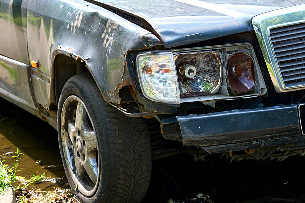 istock Old car with a rusty wing, a broken headlight and a flat tire 2223507719