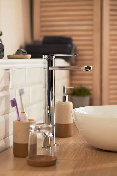 istock Modern Bathroom Sink Area Featuring Skincare Products and Toothbrushes 2223509679
