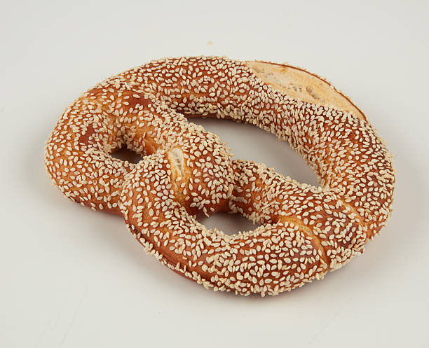 istock Twisted bread sprinkled with white sesame seeds isolated nature background with clipping path 2223511730