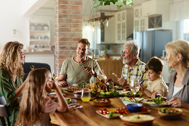istock Happy multi-generation family talking during lunch at home. 2223511854