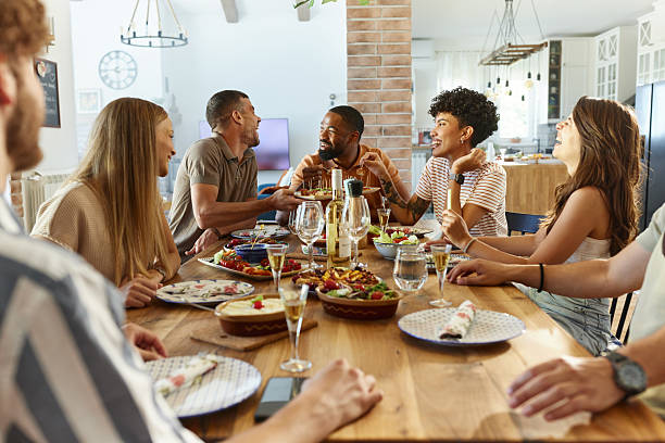 istock Cheerful friends having fun during a meal at dining table. 2223512449