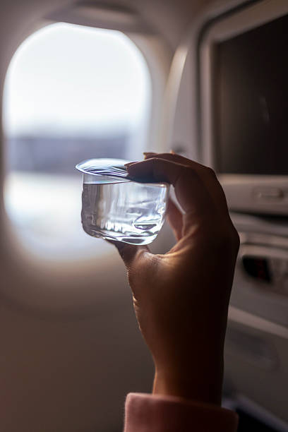 istock Passenger perspective, looking out the airplane window while enjoying a drink 2223513450