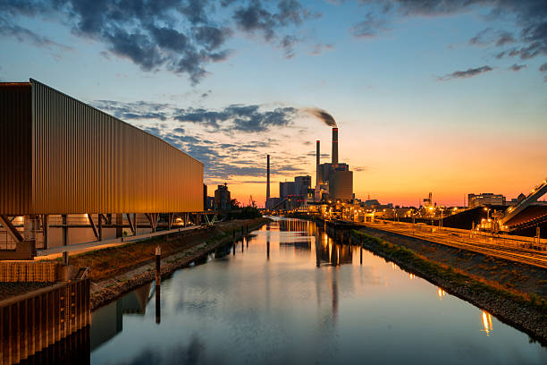 colorful illuminated silhouette of power station in Mannheim at blue hour
