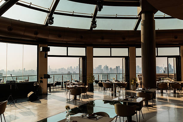 istock Sunlit elegant bar terrace with city and sky views 2223515009