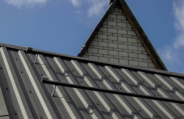 istock A man is installing solar panel mounts on the roof. Selective focus 2223515023
