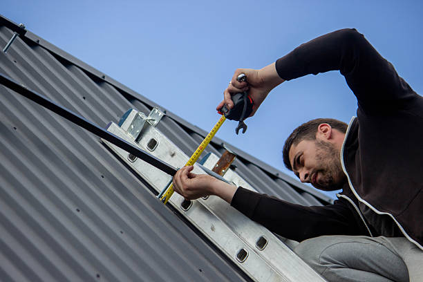istock A man is installing solar panel mounts on the roof. Selective focus 2223515044