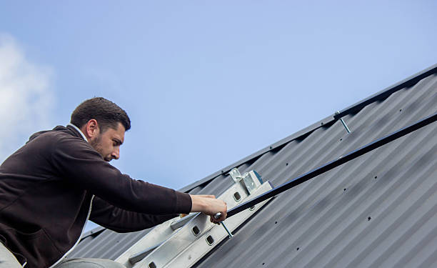 istock A man is installing solar panel mounts on the roof. Selective focus 2223515049