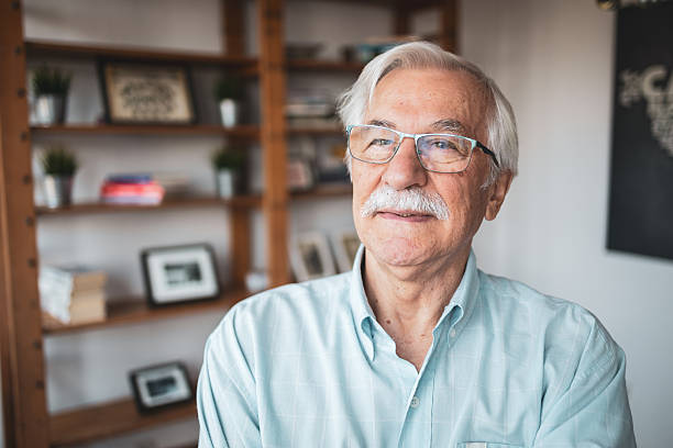 istock Senior man relaxing in cozy home library 2223515192