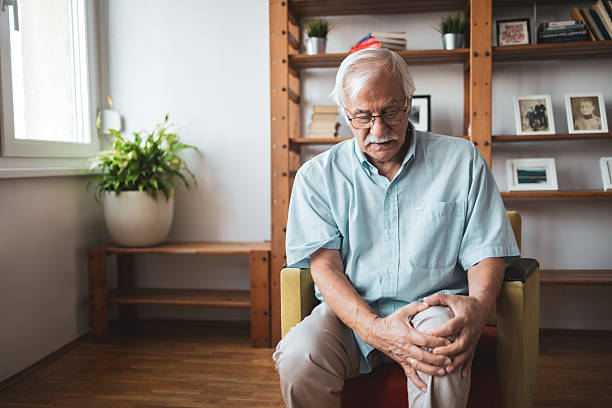 istock Senior man experiencing knee pain at home 2223515197