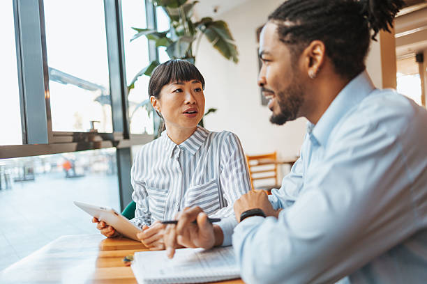 istock Two business colleagues discussing work in a cafe 2223515338