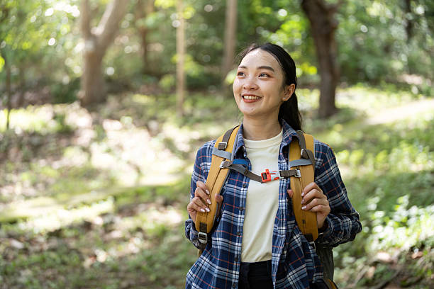 istock Joyful Hiking. Smiling woman with backpack enjoying nature. 2223516314