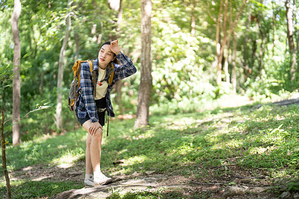 istock Nature Exploration. Young woman taking a break while hiking in a vibrant forest. 2223516937