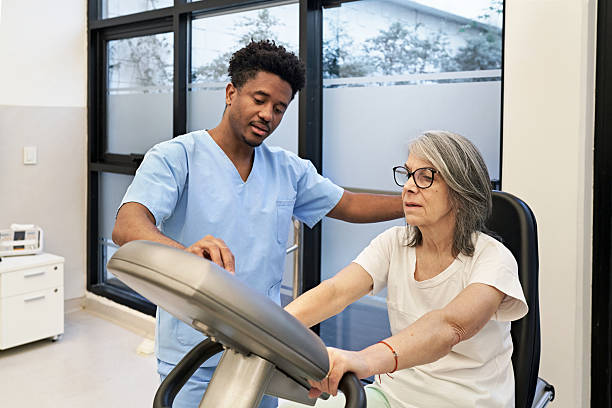 istock Physical therapist customizing workout on stationary bicycle 2223517176
