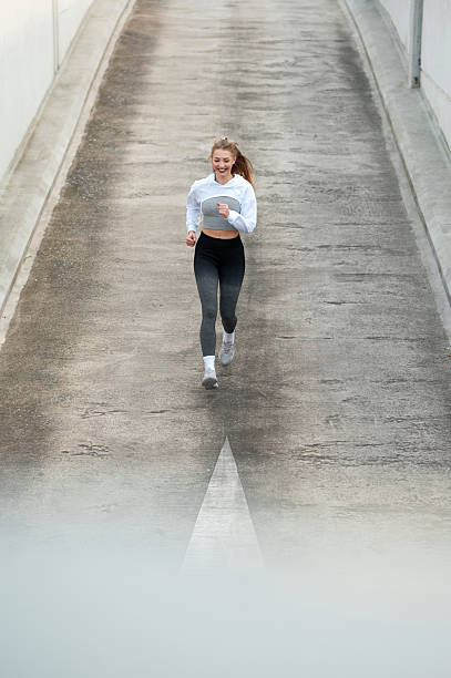 istock Woman Jogging on Concrete Path 2223518833