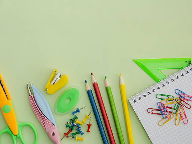 istock Flat stand with school stationery on a green background, top view 2223521698