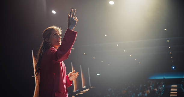 istock Successful Company Manager Delivering a Positive Earnings Report at a Shareholders Event. Female Public Speaker Sharing Statistics, Future Goals and Leadership Insights to the Guests in the Room 2223522158