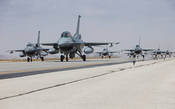 istock F-16  Fighter Jet in line for take off 2223522401