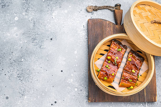 istock Unagi eel, Japanese grilled eel with sweet soy sauce. grey background. top view 2223522509