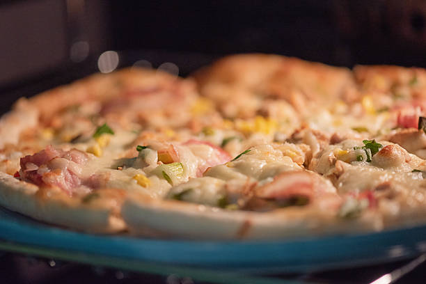 istock Ready-made pizza with bacon and cheese on a blue plate. 2223522782