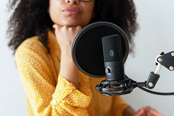 istock Young Woman Recording Podcast with Microphone 2223522839