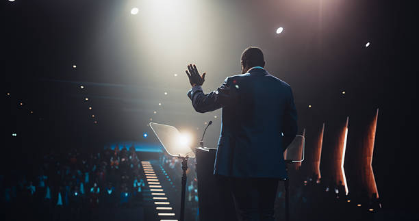 istock Anonymous Black Personal Growth Keynote Speaker Delivering a Motivational Speech on Stage, Hosting a Psychology Seminar to Help Entrepreneurs Overcome Their Personal and Professional Challenges 2223522887
