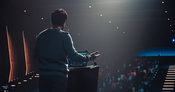 istock South Asian Personal Growth Keynote Speaker Using Laptop and Delivering a Motivational Speech on Stage, Hosting a Seminar to Help Entrepreneurs Overcome Their Personal and Professional Challenges 2223523872