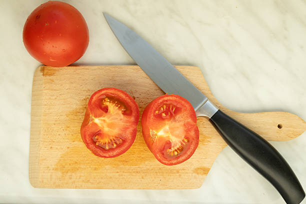 istock fresh tomatoes and kitchen knife on cutting board 2223523878
